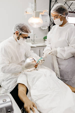 Dentists In Scrubs With Patient Dentistry Wallpaper