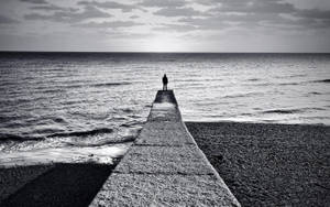 Depressed Man On Stone Dock Wallpaper