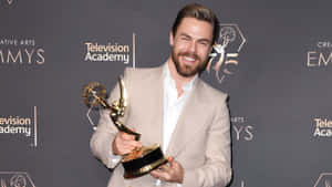 Derek Hough Holding Emmy Award Wallpaper