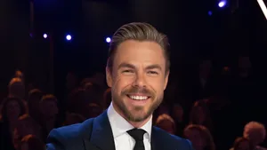 Derek Hough Smiling On Stage Wallpaper