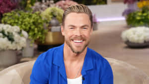 Derek Hough Smiling On Talk Show Wallpaper