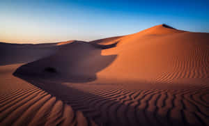 Desert Beauty: Majestic Sand Dunes At Sunset Wallpaper