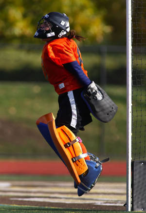 Determined Field Hockey Goalkeeper In Action Wallpaper