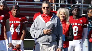 Determined Football Coach Analyzing The Game Wallpaper