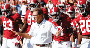Determined Football Coach Strategizing Game Plan Wallpaper