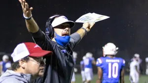 Determined Football Coach Strategizing On The Field Wallpaper