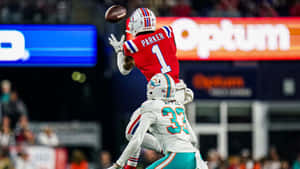 Devante Parker Catching Football Against Defender Wallpaper