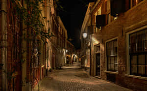 Deventer Nighttime Cobblestone Street Wallpaper