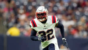 Devin Mccourty In Action During A Football Game Wallpaper