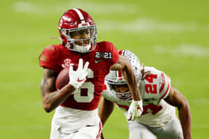 Devonta Smith Catching Football During Game Wallpaper