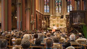 Devoted Worshippers In Holy Eucharist Celebration Wallpaper