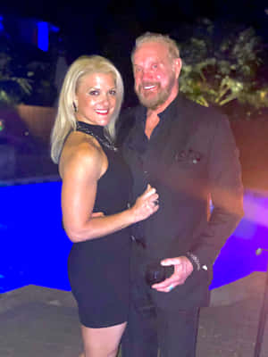 Diamond Dallas Page Posing With Payge Mcmahon. Wallpaper