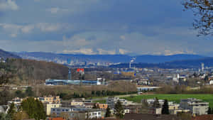 Dietikon Cityscapewith Alps Background Wallpaper