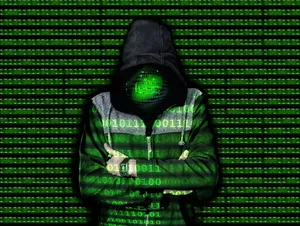 Digital_ Hooded_ Figure_in_ Matrix_ Code_ Background.jpg Wallpaper