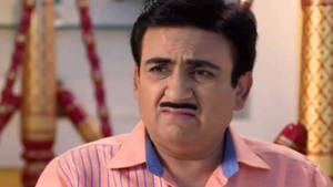 Dilip Joshi Portraying The Vibrant Character Jethalal In A Pink Polo Wallpaper