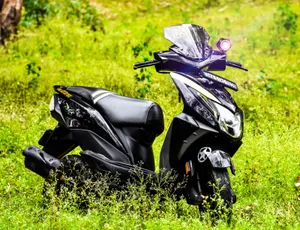 Dio Bike Parked On Bushes Wallpaper