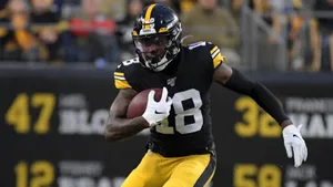 Diontae Johnson In Action On The Football Field Wallpaper