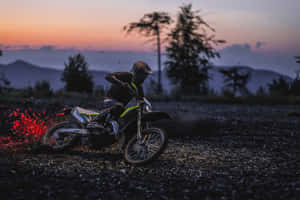 Dirt Bike Riderat Dusk Wallpaper