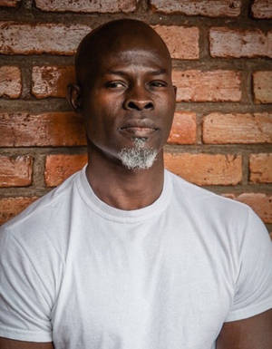 Djimon Hounsou On Brick Wallpaper