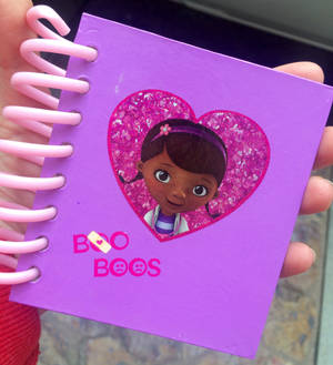 Doc Mcstuffins With Her Big Book Of Boo-boos Wallpaper