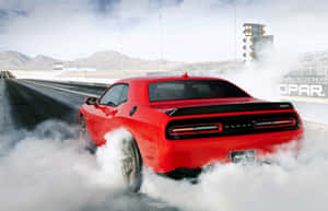 Dodge Challenger Srt - A Red Car Driving Down A Track Wallpaper