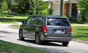 Dodge Grand Caravan Driving Suburban Street Wallpaper