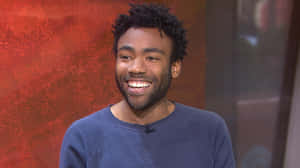 Donald Glover Smiling During Interview Wallpaper