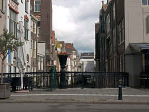 Dordrecht Historic Cityscape With Canal Bridge Wallpaper