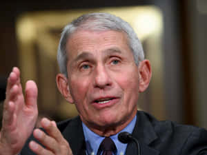 Dr. Anthony Fauci Delivering A Public Health Announcement Wallpaper