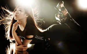 Dramatic_ Backlit_ Female_ Performer Wallpaper