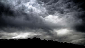 Dramatic Dark Storm Unleashing Its Fury Over A Landscape Wallpaper