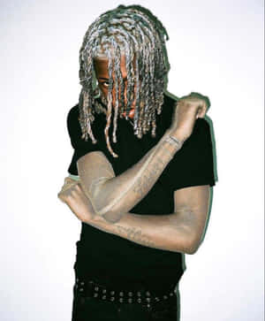 Dreadlocked_ Figure_in_ Black_ Tee Wallpaper