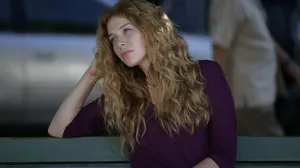 Dreamy Looking Woman Leaningon Railing Wallpaper