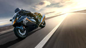 Driving A Motorcycle Through The Mountains Wallpaper