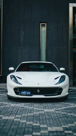 Driving Luxury In Style With A White Ferrari Iphone. Wallpaper