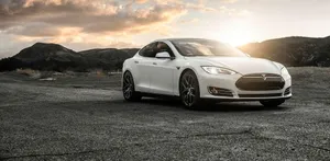 Driving The Future: Sleek Hybrid Car On A Scenic Road Wallpaper