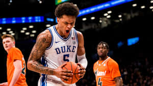 Duke Basketball Player Intense Game Moment Wallpaper