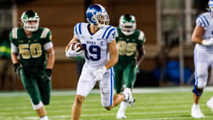 Duke Football Player Running With Ball Wallpaper