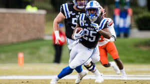 Duke Football Player Running With Ball Wallpaper