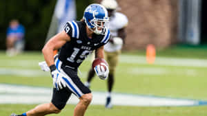 Duke Football Player Running With Ball Wallpaper