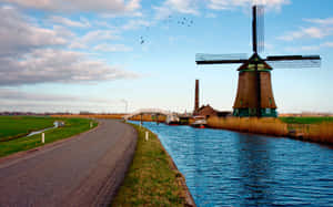 Dutch Windmill Beside Waterway Wallpaper