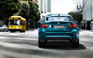 Dynamic Bmw X6 Cruising Down The Highway Wallpaper