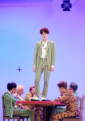 Dynamic Bts Mv Group Shot On Stylish Urban Stage Wallpaper