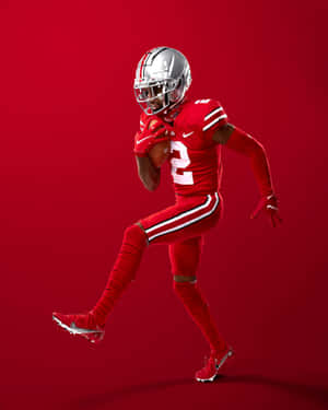 Dynamic Football Player Red Backdrop Wallpaper