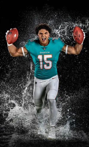 Dynamic Football Player Water Splash Wallpaper