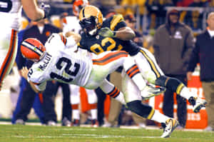 Dynamic Football Tackle In Action Wallpaper