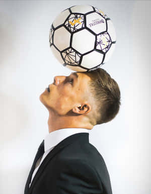 Dynamic Freestyle Soccer Action In Urban Setting Wallpaper