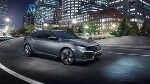 Dynamic Hatchback On The Road Wallpaper