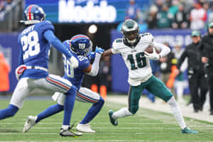 Eagles Player Quez Watkins Evades Tackle Wallpaper