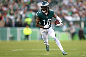 Eagles Player Running With Football Wallpaper